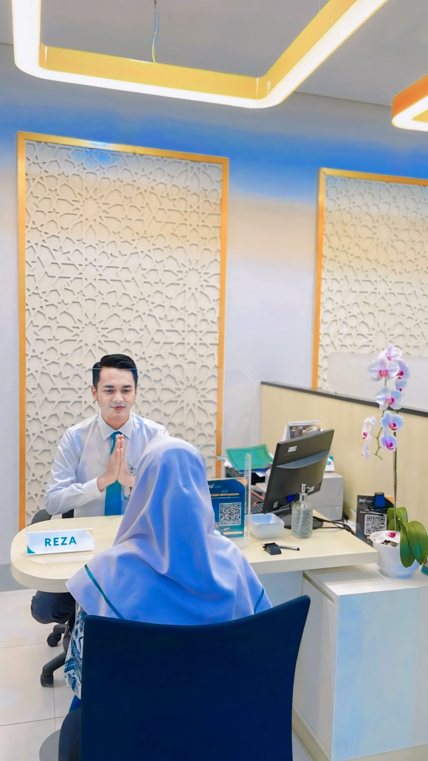 Karyawan BSI memberikan pelanan ke nasabah.